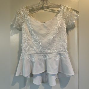 Bebe white peplum top with lace details. Off or on the shoulder sleeves